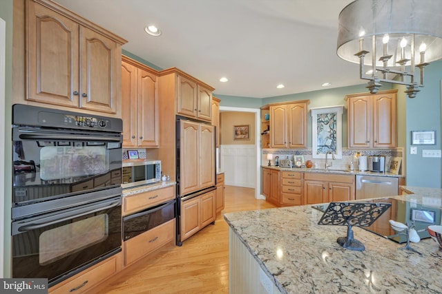 kitchen with open shelves, light stone countertops, a sink, a warming drawer, and stainless steel appliances
