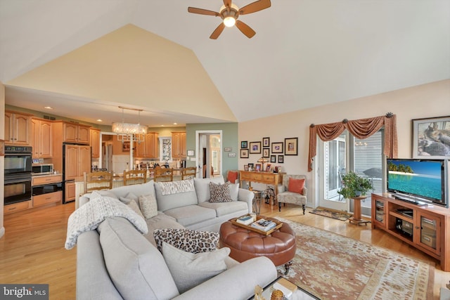 living room with light wood-style floors, a ceiling fan, recessed lighting, and high vaulted ceiling
