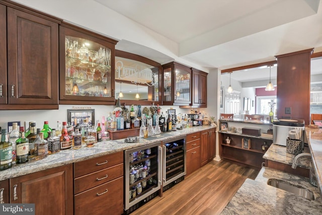 bar with a bar, a sink, dark wood-style flooring, and wine cooler