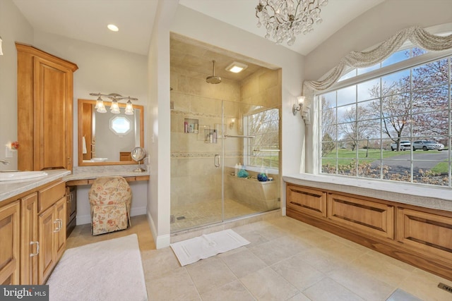 full bath with vanity, tile patterned floors, a chandelier, a shower stall, and lofted ceiling