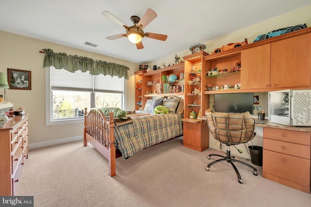 bedroom featuring visible vents, baseboards, ceiling fan, and light carpet