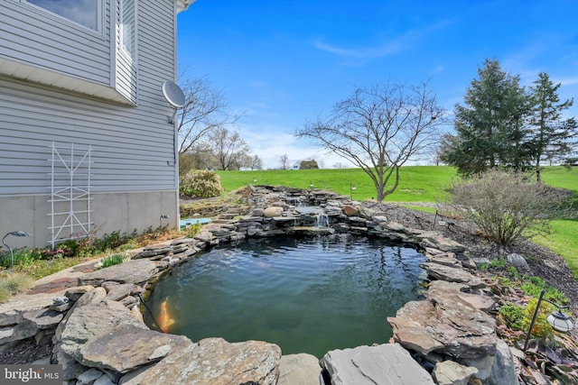 exterior space with a garden pond