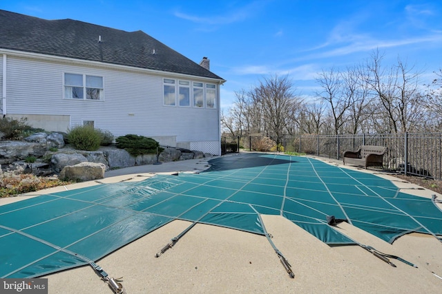 view of swimming pool featuring a fenced in pool and fence