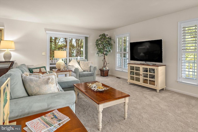 carpeted living area with baseboards