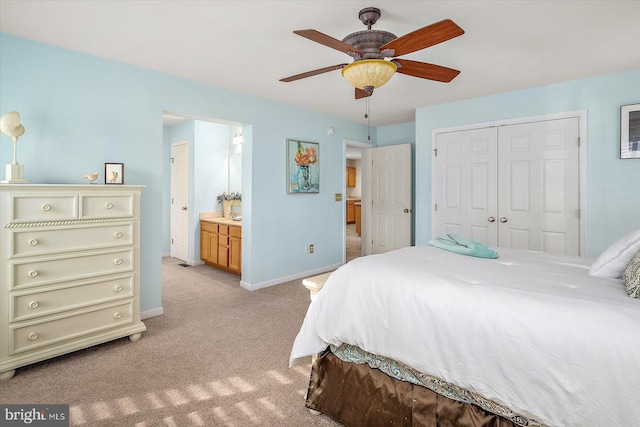 bedroom featuring ceiling fan, baseboards, a closet, ensuite bathroom, and light carpet