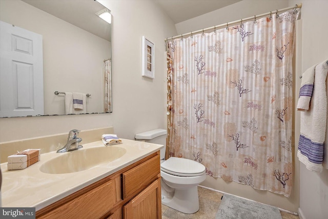 bathroom featuring toilet, a shower with shower curtain, tile patterned flooring, and vanity