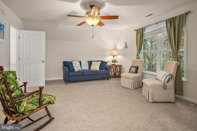 carpeted living area with visible vents, a ceiling fan, and baseboards