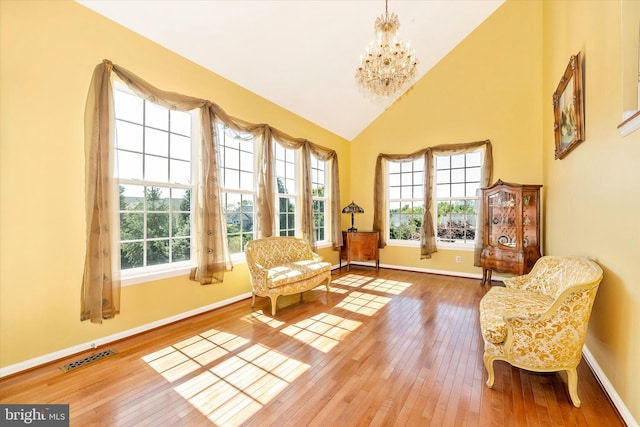 9743 Wyndham Dr, Frederick, MD 21704 - sitting room with plenty of natural light, hardwood / wood-style floors, a chandelier, high vaulted ceiling, and baseboards