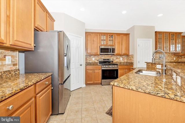 9743 Wyndham Dr, Frederick, MD 21704 - kitchen featuring stainless steel appliances, a sink, decorative backsplash, light tile patterned floors, and glass insert cabinets