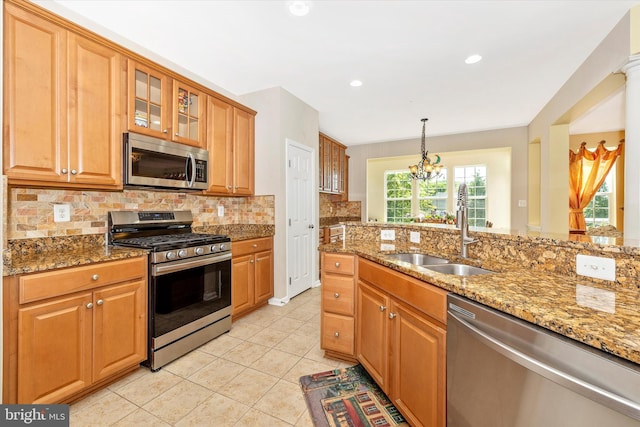 9743 Wyndham Dr, Frederick, MD 21704 - kitchen featuring appliances with stainless steel finishes, a sink, backsplash, a chandelier, and light stone countertops