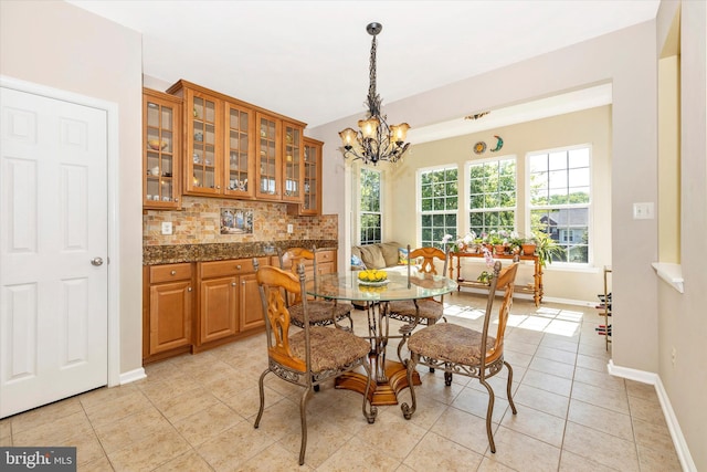 9743 Wyndham Dr, Frederick, MD 21704 - dining area with a chandelier, light tile patterned flooring, and baseboards
