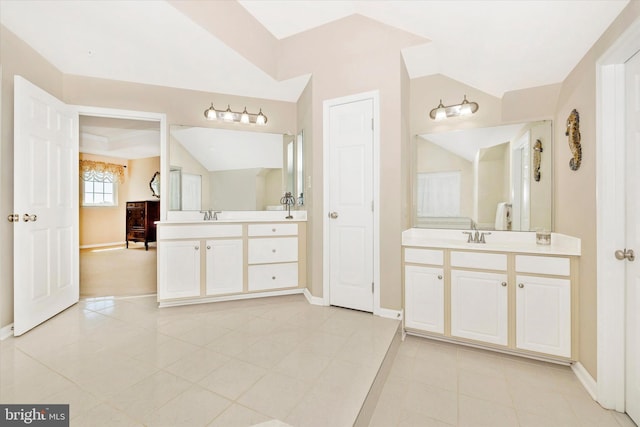 9743 Wyndham Dr, Frederick, MD 21704 - bathroom with vaulted ceiling, baseboards, two vanities, and tile patterned floors