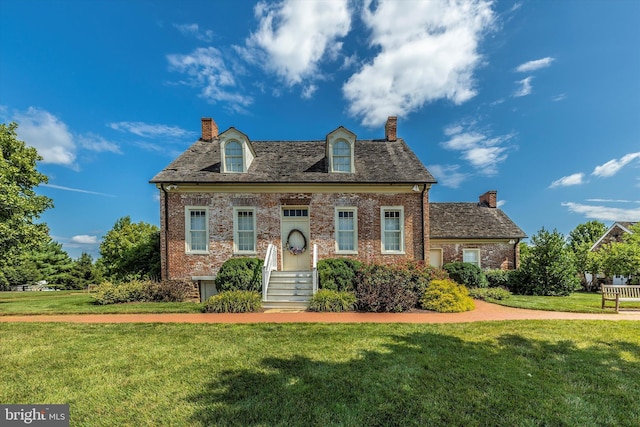 9743 Wyndham Dr, Frederick, MD 21704 - cape cod house featuring a chimney, a front lawn, and brick siding