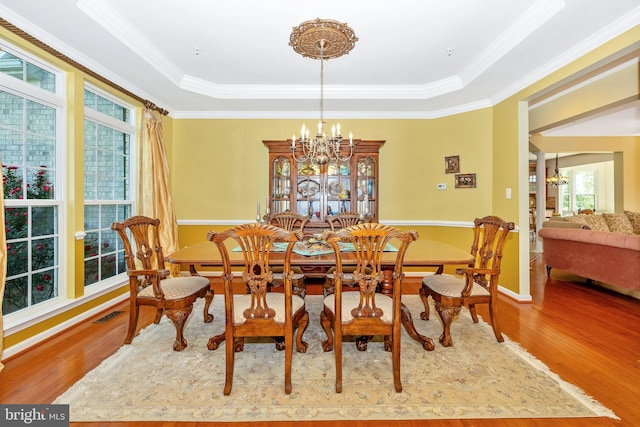 9743 Wyndham Dr, Frederick, MD 21704 - dining space featuring a chandelier, wood finished floors, ornamental molding, and a raised ceiling