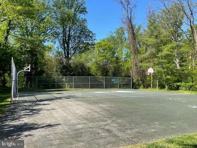 view of basketball court featuring community basketball court and fence