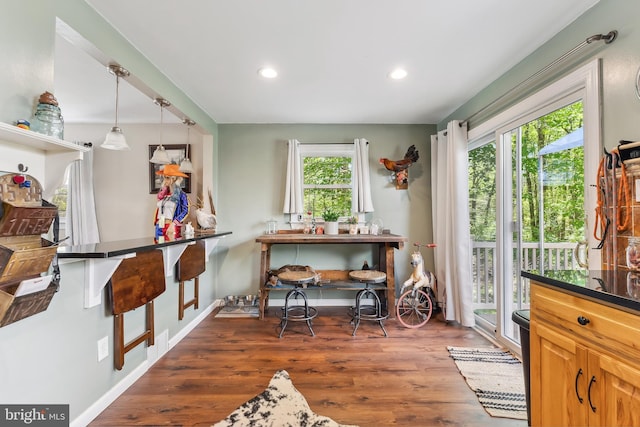 interior space featuring recessed lighting, baseboards, and wood finished floors