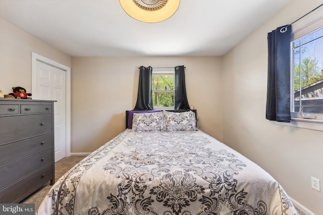 carpeted bedroom featuring baseboards