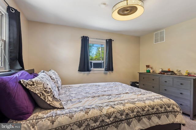 bedroom featuring carpet flooring and visible vents