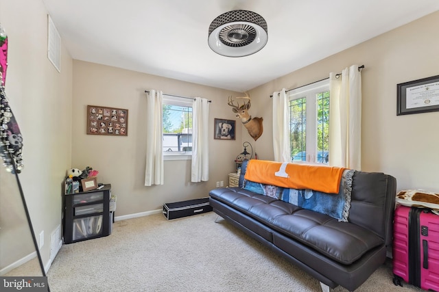 living area featuring carpet floors, baseboards, and visible vents