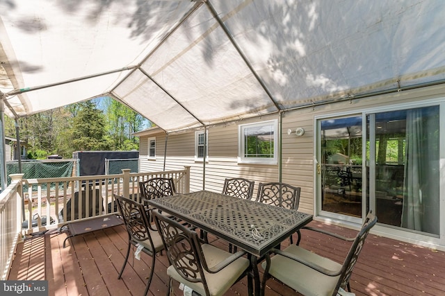 wooden deck with a storage shed, an outdoor structure, and outdoor dining area