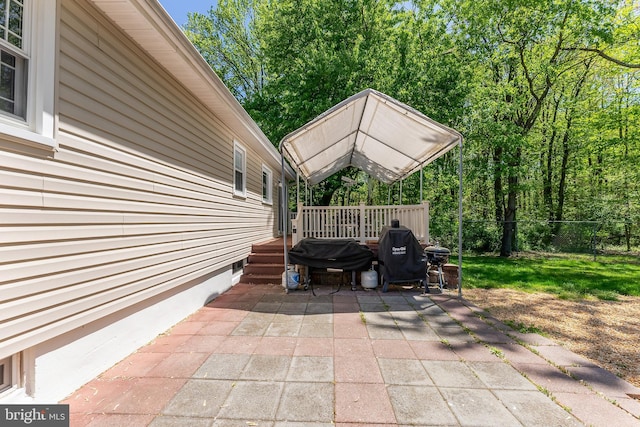 view of patio featuring grilling area and a deck