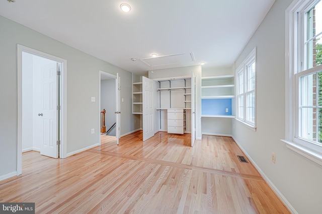 2 S Manchester St S, Arlington, VA 22204 - unfurnished bedroom with attic access, multiple windows, light wood-style floors, and baseboards