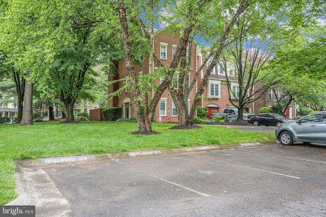 2 S Manchester St S, Arlington, VA 22204 - view of property with uncovered parking, a front yard, and brick siding