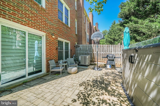 view of patio with fence and central AC unit