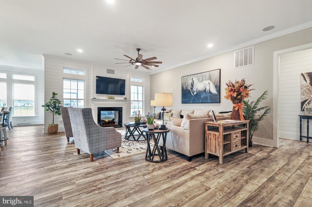 404 Wiggins Mill Rd, Townsend, DE 19734 - living area with a multi sided fireplace, a ceiling fan, wood finished floors, and visible vents