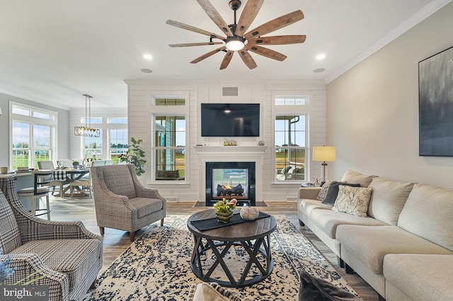 404 Wiggins Mill Rd, Townsend, DE 19734 - living area with crown molding, wood finished floors, recessed lighting, a ceiling fan, and a multi sided fireplace