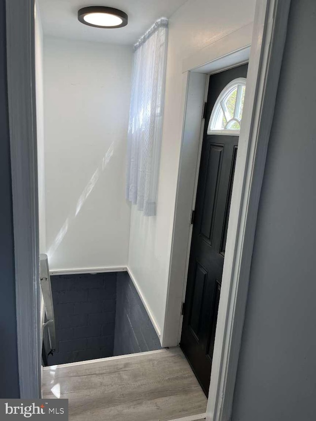entrance foyer with wainscoting and wood finished floors