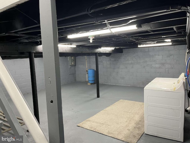 unfinished below grade area featuring washer / clothes dryer and electric panel