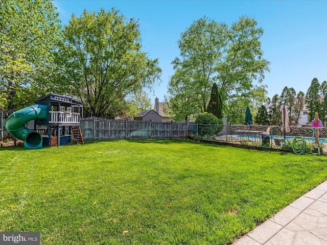 view of yard with a playground and a fenced backyard