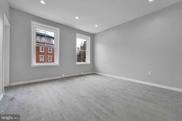 unfurnished room with recessed lighting, baseboards, and baseboard heating