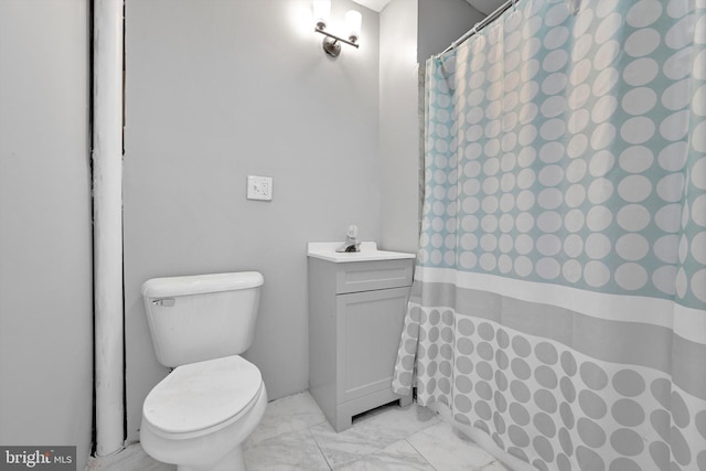 bathroom featuring a sink, marble finish floor, a shower with shower curtain, and toilet