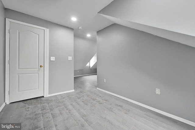 interior space featuring recessed lighting, baseboards, and wood finished floors
