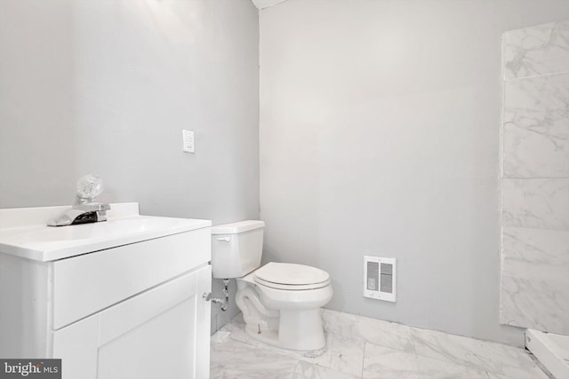 bathroom featuring toilet, visible vents, marble finish floor, and vanity