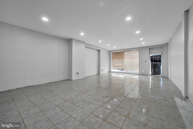 spare room featuring recessed lighting, light tile patterned floors, and visible vents