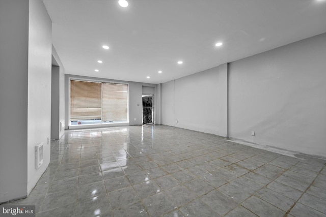 unfurnished living room featuring recessed lighting and visible vents