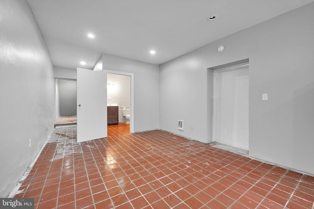 spare room featuring recessed lighting and visible vents