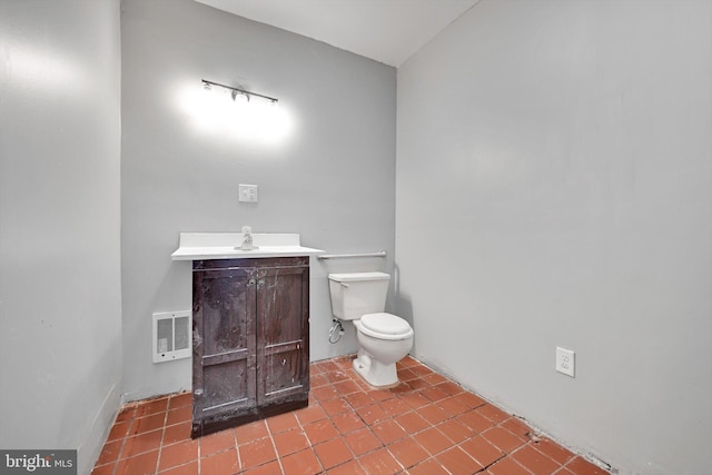bathroom with tile patterned flooring, visible vents, toilet, and vanity