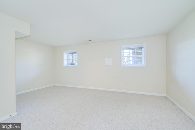 interior space featuring a healthy amount of sunlight, carpet floors, and baseboards