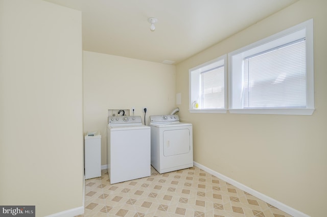 washroom with separate washer and dryer, laundry area, and baseboards
