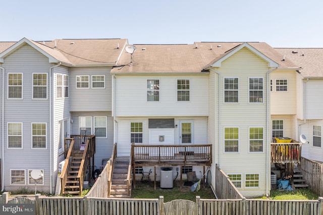 rear view of property featuring stairway, central AC, a wooden deck, and a fenced backyard