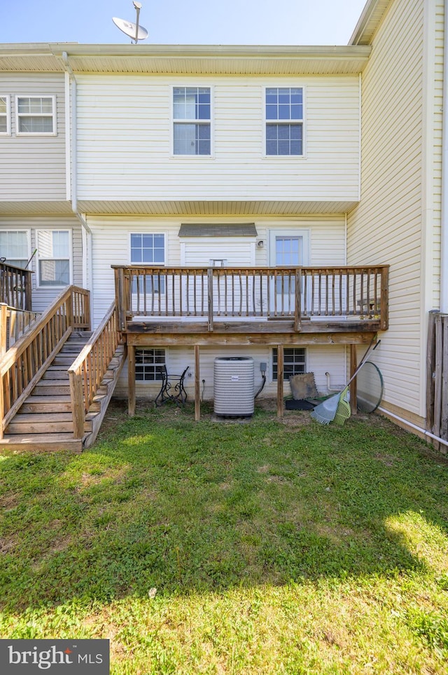 rear view of house with stairs, a lawn, a wooden deck, and cooling unit