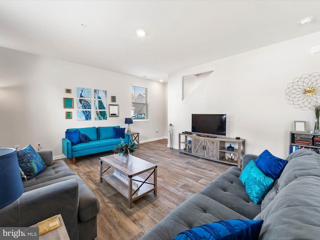 living room featuring recessed lighting, baseboards, and wood finished floors