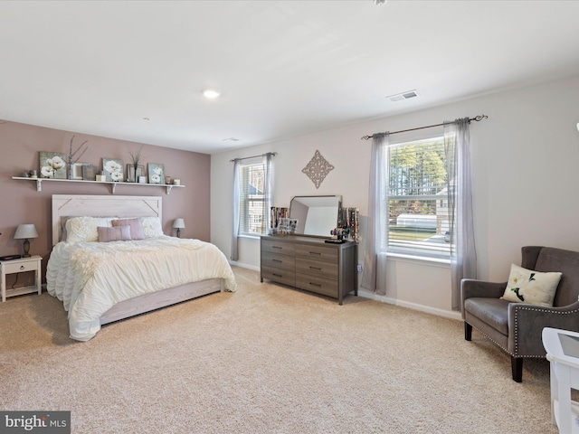 bedroom featuring baseboards, visible vents, and carpet