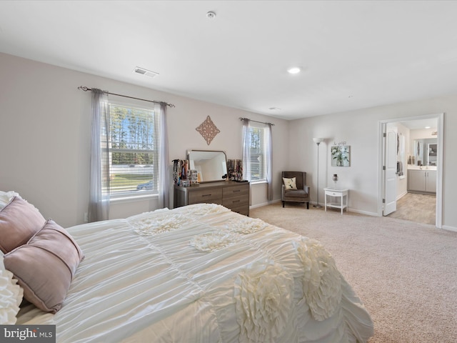 carpeted bedroom with baseboards, visible vents, and multiple windows