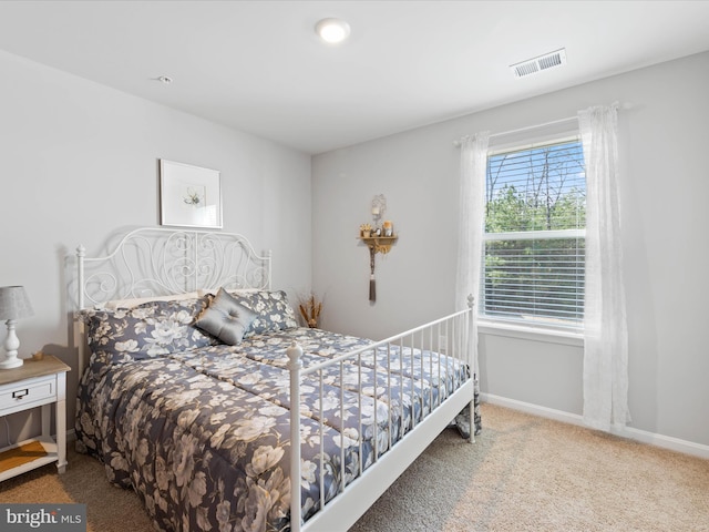 bedroom with baseboards, carpet, and visible vents