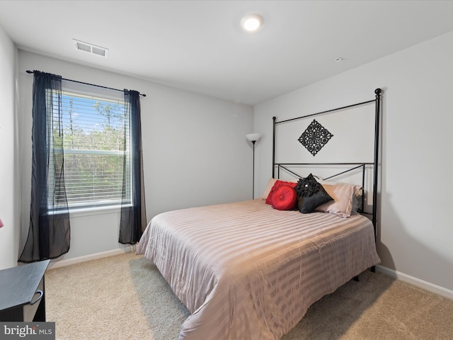 carpeted bedroom with baseboards and visible vents